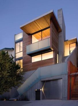 Sandblasted glass walls and railings lend protection and privacy without obscuring light in stairwells and the street-front balcony. The balcony adds a few extra feet to the living room and provides sun control for the western exposure.