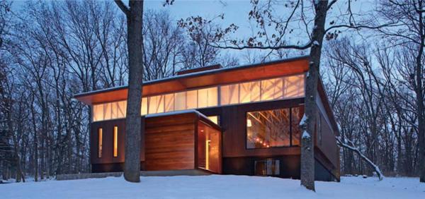 A clerestory of energy-efficient, gel-filled polycarbonate fills the interiors with gentle northern light. The cedar-sided entry addition periscopes through the house as a circulation spine, emerging at rooftop level in the form of a loftlike study.