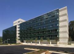 The dorm building comprises two interlocking boxes, one concrete and one glass. Graceful steel sunshades define the glass curtain walls while providing protection along the southern exposure.