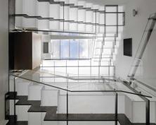 The view from the lower level up through the top floor skylight shows how the staircase distributes light throughout the house.