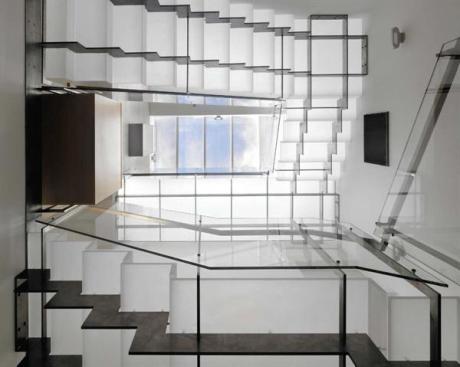 The view from the lower level up through the top floor skylight shows how the staircase distributes light throughout the house.