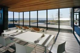 Recessed glass walls create view portals of the salt marsh, pine forest, and river.