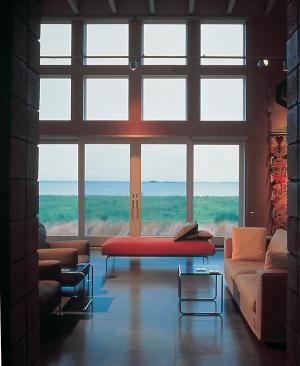 "This house is like a huge porch surrounded by grasses," architect Suman Sorg says. Doors and windows in the living room look west over the Chesapeake Bay.