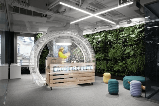 The+pine-slat+reception+desk+at+the+new+Bausch+%2b+Lomb+offices+in+Warsaw%2c+Poland%2c+is+encased+in+an+inflated+vinyl+bubble.