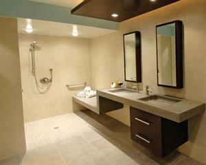 The shower's parallel "wet" and "dry" benches allow a caretaker to stay dry while helping the client's son bathe.