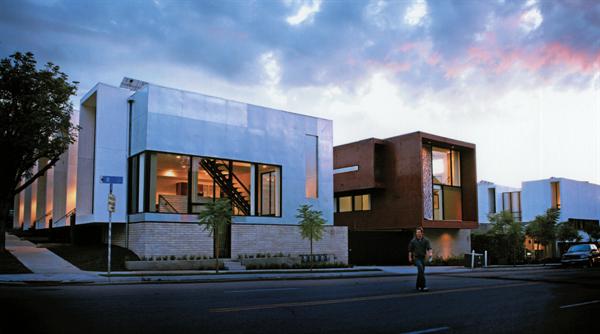 Segal adapted an old union hall (clad in mild steel at left) as an office and two studio apartments and added three new buildings on adjacent parking lots.