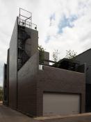 The four story homes kitchen opens onto a landscaped rear terrace.
