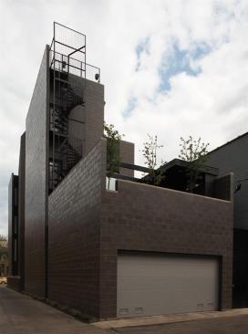 The four story homes kitchen opens onto a landscaped rear terrace.