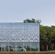 The main entrance to the EcoHawks facility is marked by a glass canopy with integrated photovoltaics from Suniva.