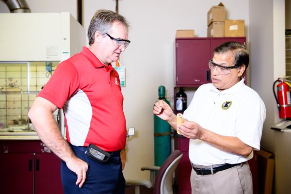 Scott Spear (left), a research engineer with the University of Alabama's Innovation and Mentoring of Entrepreneurs center, and Anwarul Haque, an associate professor of aerospace engineering and mechanics at the university, examine a spool of the novel cellulose fiber.