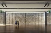 A former prison wall serves as a rugged backdrop for the streamlined events space.