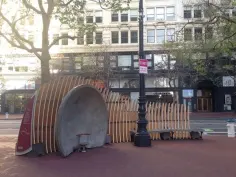 Two concrete bandstands face off one another across a plaza, allowing people seated inside them to hear each other across the way.