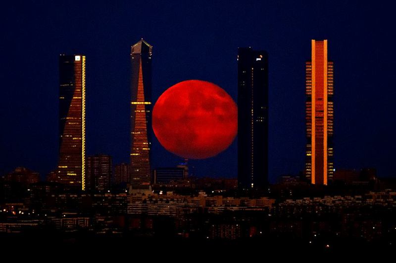 The moon over the Cuatro Torres Business Area in Madrid, Spain, on Monday.