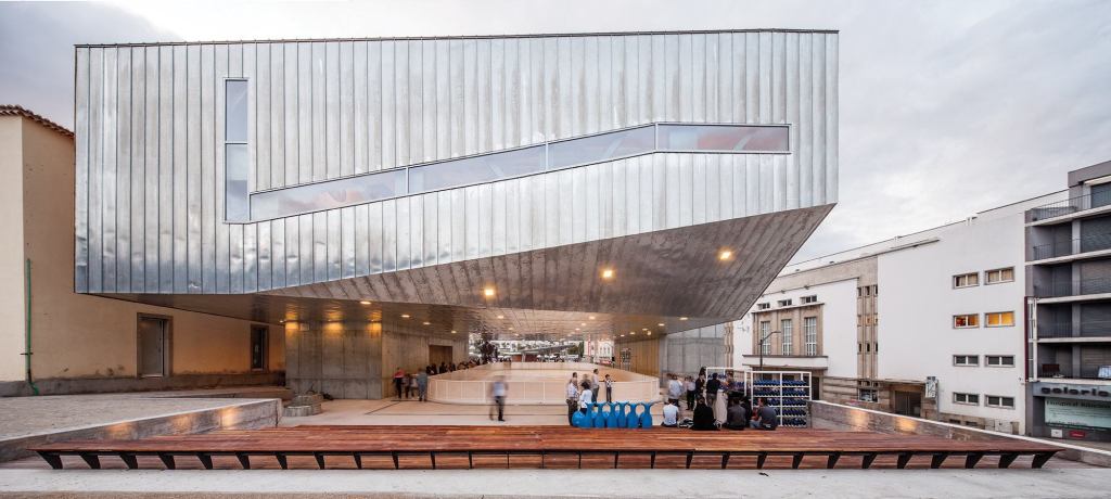 Josep Lluís Mateo designed the Cultural Center to float above the Praça Largo da Devesa, which his firm designed during phase one of the urban revitalization plan for Castelo Branco, Portugal. He says he wanted to produce a “unitary, continuous building, with roofs, floors and façades that were equivalent to each other.” Directly beneath the building is an ice rink.