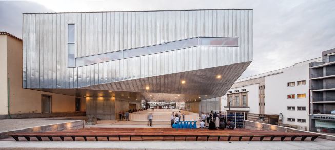 Josep Lluís Mateo designed the Cultural Center to float above the Praça Largo da Devesa, which his firm designed during phase one of the urban revitalization plan for Castelo Branco, Portugal. He says he wanted to produce a “unitary, continuous building, with roofs, floors and façades that were equivalent to each other.” Directly beneath the building is an ice rink.