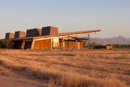 The+structures+metaphorically+grow+out+of+the+desert+floor%2c+and+are+sited+to+capture+dramatic+views+to+the+Sierra+Estrellas.