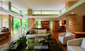 The main feature of this contemporary residential home is clear: its windows. The large amount of windows allow the passerby to appreciate the expertly arranged interior -- allowing the interior and exterior of the home to intermingle.