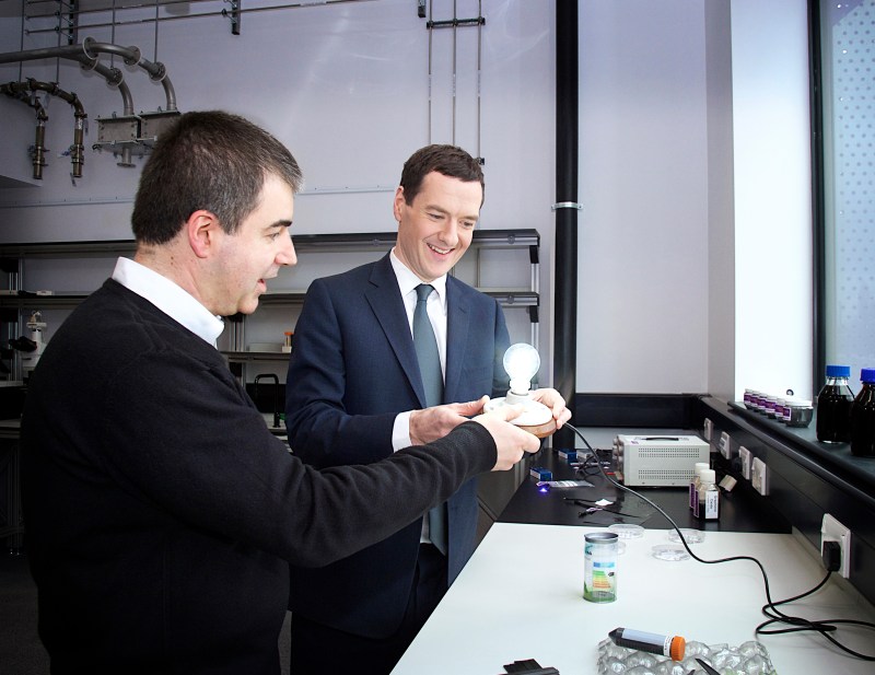 U.K. chancellor George Osborne (right) with Kostya Novoselov, a University of Manchester researcher who helped isolate graphene in 2004, with the graphene light bulb.