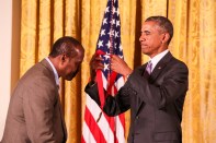 President Barack Obama (right) presents Everett Fly (left) with a 2014 National Humanities Medal.