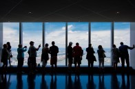 Tourists view New York from the One World Trade Center observation deck.