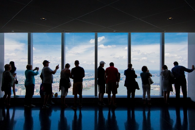 Tourists view New York from the One World Trade Center observation deck.