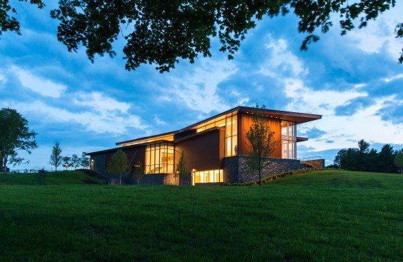 The view from Vermont's Route 7 features a two story structure with expanses of glass.