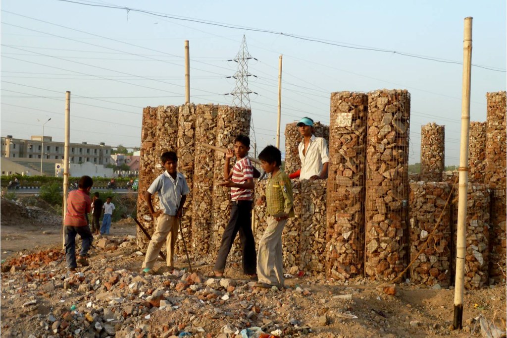 Students help construct the gabion walls of the Patangyu School in Ahmedabad, India.