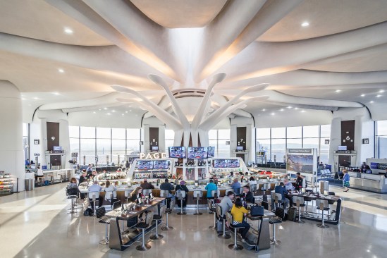 A view of the terminal at midday when the color temperature of the petal fixtures transitions to 4000K to balance the abundance of natural light.