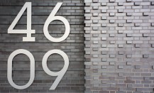 An address plaque on the façade of 46-09 Eleventh St, in Long Island City, N.Y.