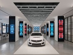 The latest models from Cadillac are displayed on a runway where a combination of light source technologies highlights the automobiles’ forms and features.