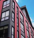 The 35 South Huntington multifamily structure includes custom 9-0 x 9-0 windows from Harvey Commercial Solutions. The impressive vinyl pictures windows were factory-mulled over awning windows. Black painted exteriors complement the overall design of the structure. Photo courtesy of Harvey Commercial Solutions.