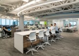 One of eight open workspace floors showing the large curvilinear LED pendant following the building’s unique shape.