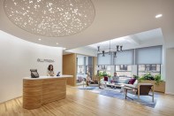 The entryway features an overhead lighting sculpture that can be activated to create a dynamic biophilic pattern on the floor below.