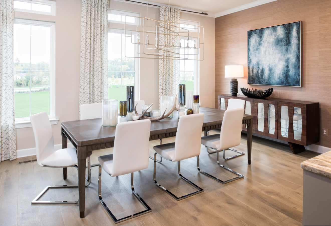 Wood flooring in light shades is especially popular this year, such as in this dining room in Miller & Smith's Brambleton Garden District community in Virginia.