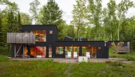 The northwest façade has a deck that faces the lake and is outfitted with Salmela-designed chairs from Loll.