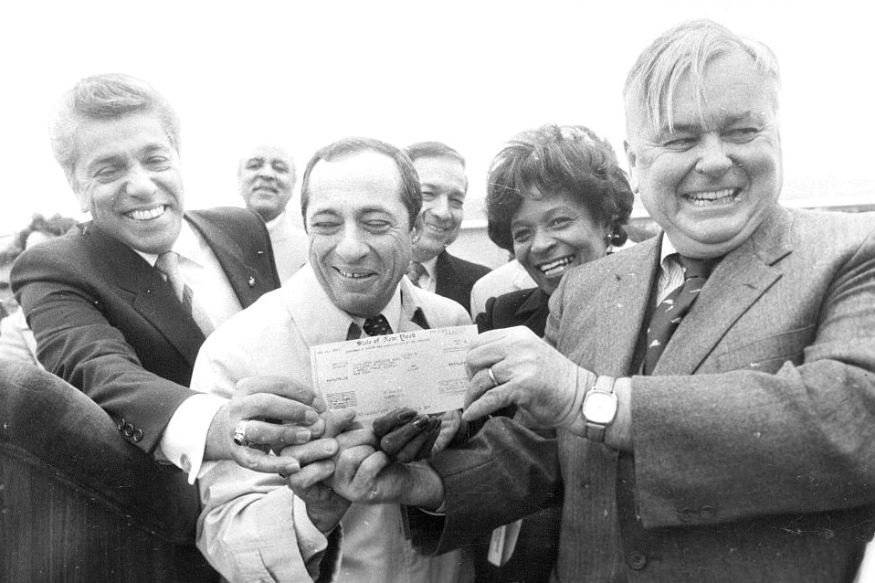 New York Governor Mario Cuomo presenting Logue (far right) and other community leaders with a check for Charlotte Gardens.