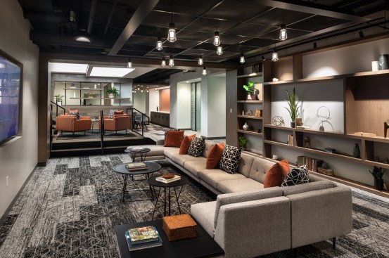 The lower lounge flows into a more casual seating area with a galley, fitness center, a work lounge, and conference center.