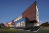 A back-lit, frosted glass portal engages traffic and serves as a billboard for the campus.