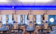 A chain of Club Pilates exercise studios in Southern California have created a signature décor built around a
Ceilume decorative thermoformed ceiling with a blue glow lighting up the edge.