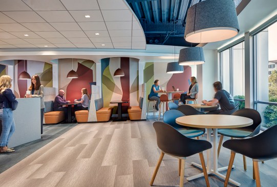 Break room is activated with modern colors in a bold wall graphic.