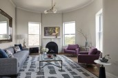 Living room with relocated fireplace and restored plaster ceiling trims