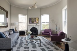 Living room with relocated fireplace and restored plaster ceiling trims