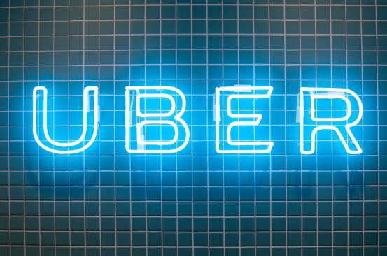 The coloured tiled walls and floors of the reception is contrasted with handcrafted neon signage 