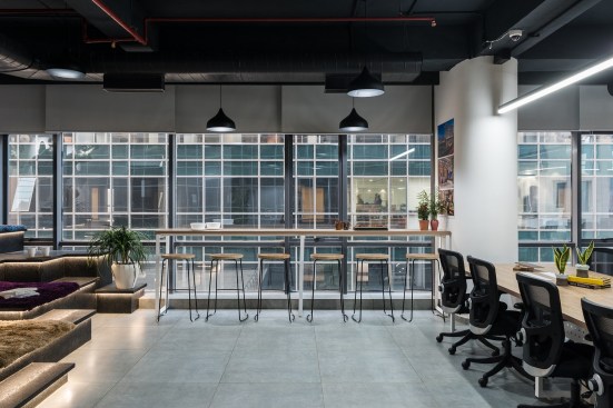 The counter height bar table and chair area serves as a team discussion area and refreshment zone.