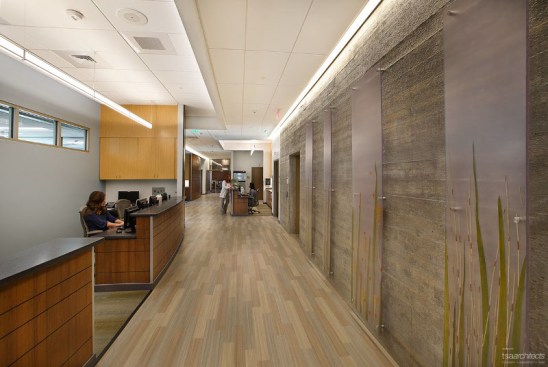 The upstairs waiting area provides visual access to the outdoors, beautiful artwork depicting nature scenes across the west, and a view to the main level.