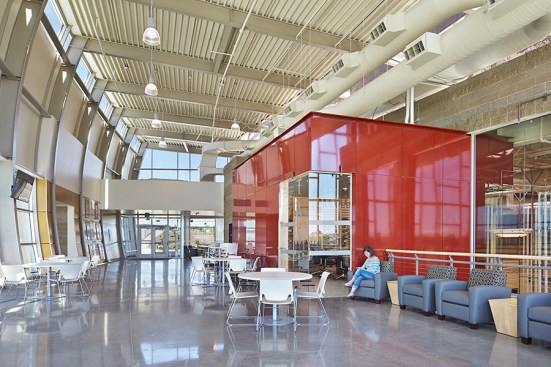 The wine library cantilevers into and over the fermentation room, where exposed interior CMU gives an industrial but warm and inviting feel.