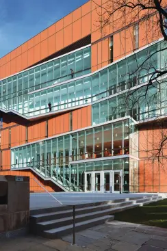 On the west side of the building, the projecting fire stair is clad in clear vision glass through which student activity can be seen, creating a dynamic fa?ade. Certain spaces?like the open area in front of the buildings elevator, seen here above the entry doors?have been claimed by students as informal study lounges. Furniture was brought in to accommodate them. "The students are in the building 24 hours," Spar says, "and they've made it their own." At the time of the building's soft opening in fall 2009, much of the break out furniture had intentionally not been ordered. Since most of it was designed by Weiss/Manfredi, the goal was to see how the pieces were used in different spaces, so that the fabrication of the pieces could meet specific needs.