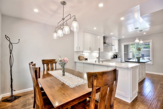 White shaker cabinet, Open space kitchen with quartz counter top. 
Wood flooring 