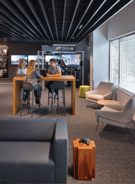 A layered linear ceiling feature inspired by speed and motion weaves through the common areas, visually connecting key moments in the space.