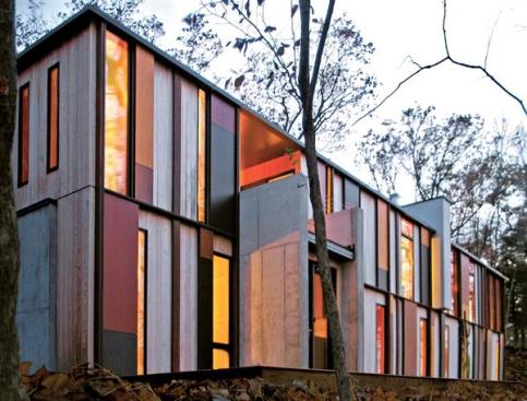 A 4 foot post and beam structure supports the vivid exterior grid. The two story side of the house looks out through the treetops and onto Green Lake.